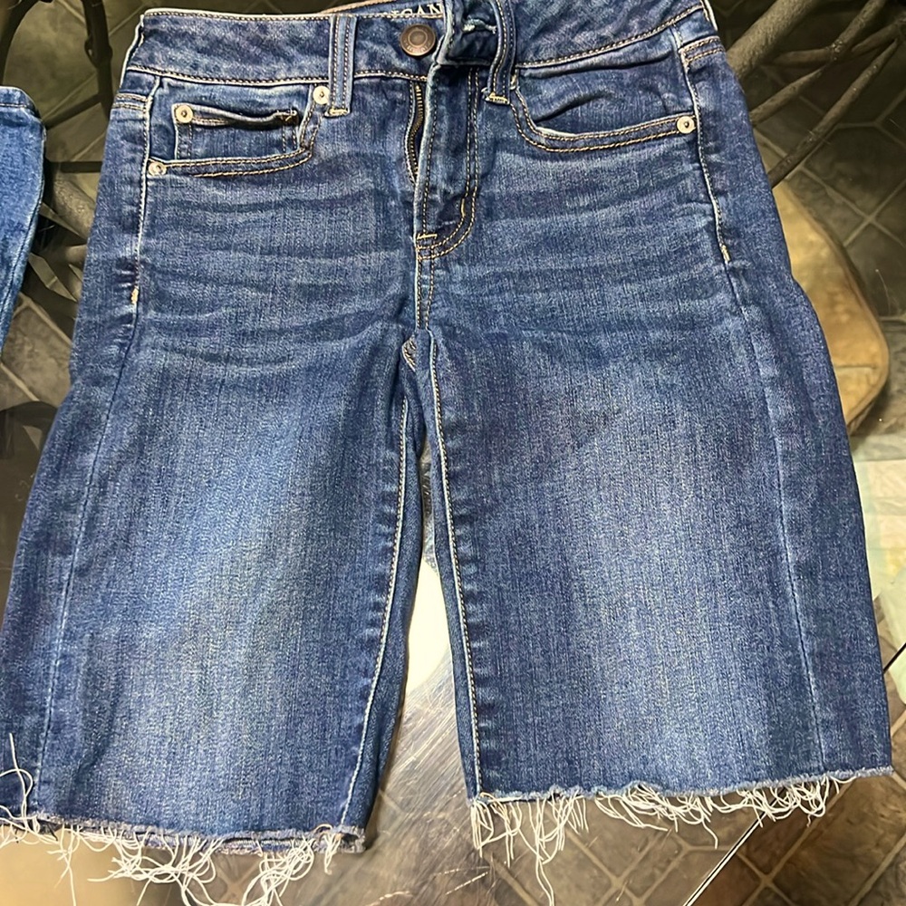 Darker denim American Eagle size 2 9” long shorts.